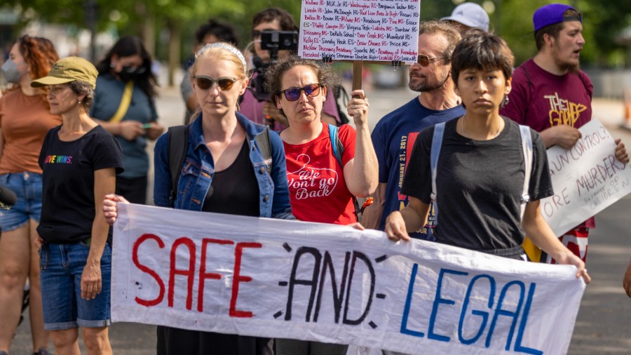 Protesters march near the Supreme Court to demand an end to gun violence and call for abortion righ...