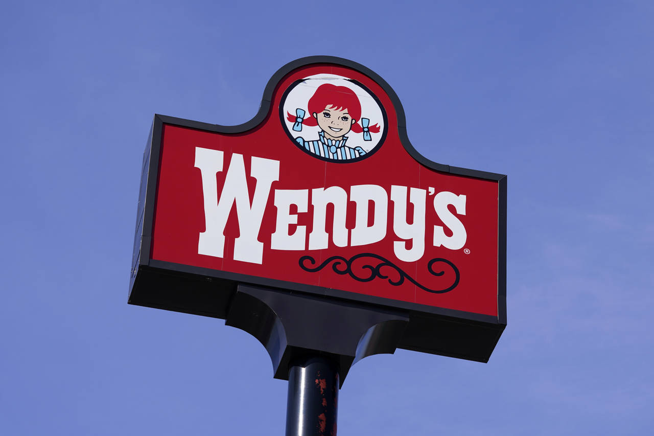 FILE - A sign stands over a Wendy's restaurant . (AP Photo/Charlie Neibergall, File)...