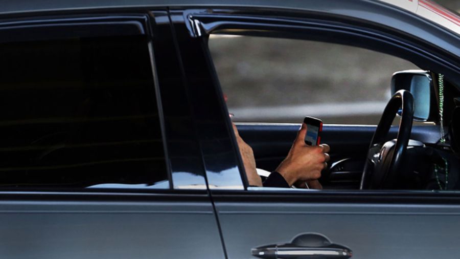 Photo: A driver uses a phone while behind the wheel of a car on April 30, 2016 in New York City....