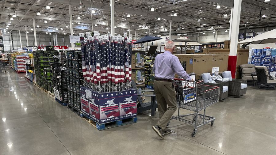 Photo: A shopper moves past a display of items in a Costco warehouse Saturday, May 18, 2024....