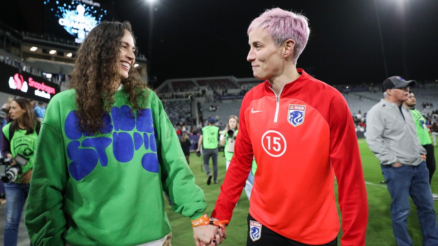 Image: Megan Rapinoe, right, holds hands with Sue Bird after OL Reign, now the Seattle Reign, lost ...