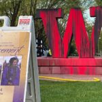 Maintenance workers arrive to clean the University of Washington "W" sign covered in red paint Tuesday morning. (Photo: Sam Campbell, KIRO Newsradio)