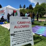 Signs can be seen at a pro-Palestinian tent encampment on the campus of the University of Washington in Seattle on Monday, April 29, 2024. (Photo: Feliks Banel, KIRO Newsradio)
