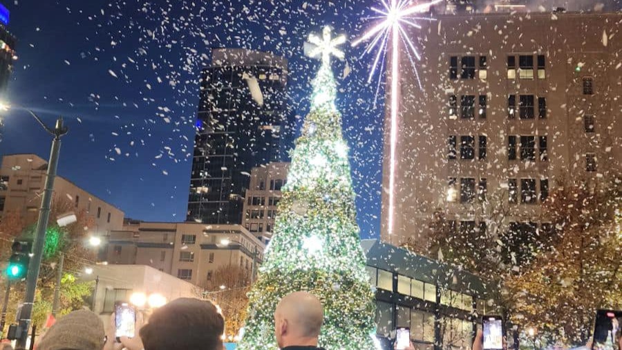 Image: People attend the lighting of the holiday tree at Seattle's Westlake Center on Friday, Nov. ...