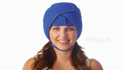 Image: A person wears a cold cap to demonstrates how it works.